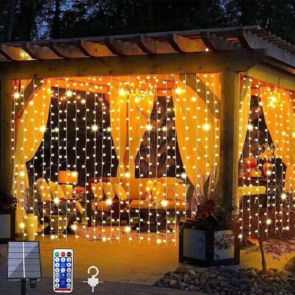 Close-up of solar-powered outdoor string lights with remote control and solar panel for garden decoration