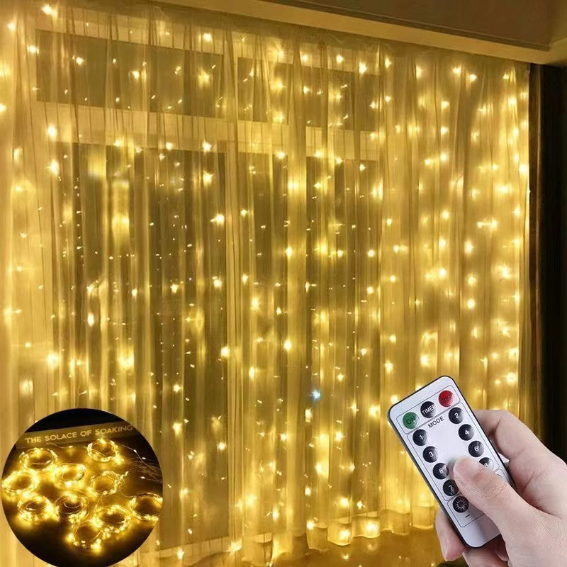 Indoor living room with yellow fairy string lights hanging from ceiling, creating a warm cozy atmosphere